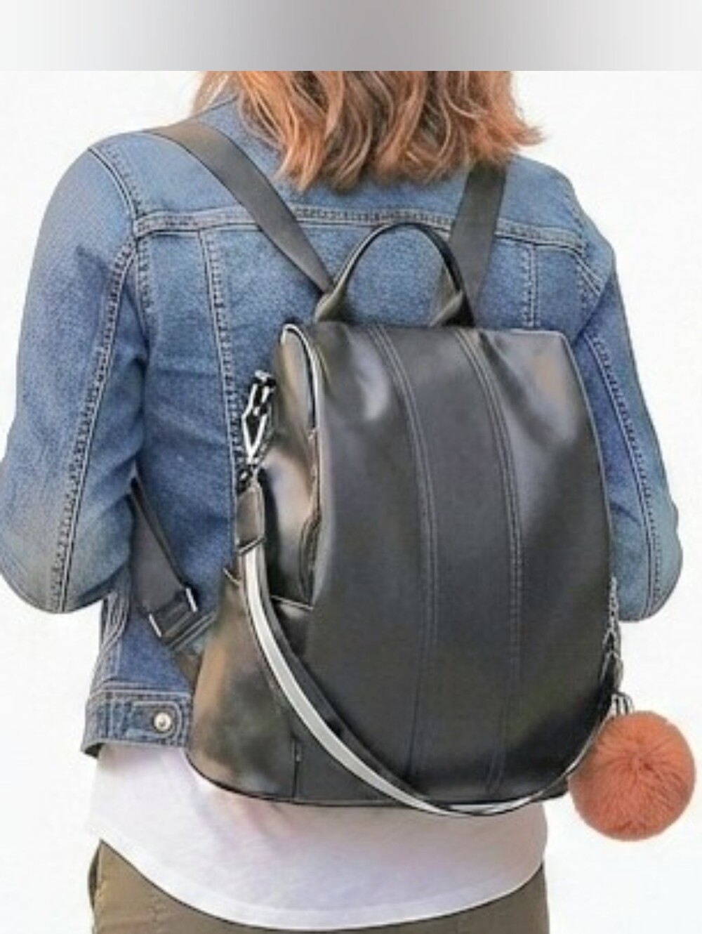 Black 2 way Convertible Vegan Leather pom pom backpack.
